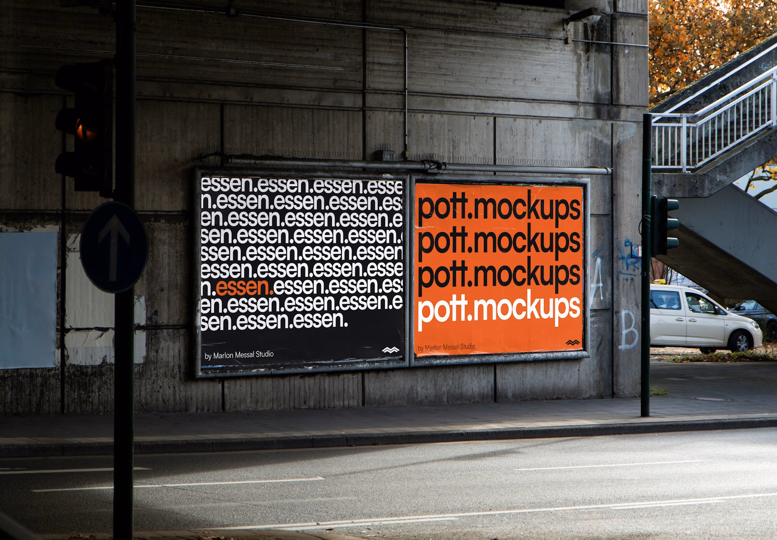 Two poster boards on a concrete wall used as a Comlabs campaign mockup