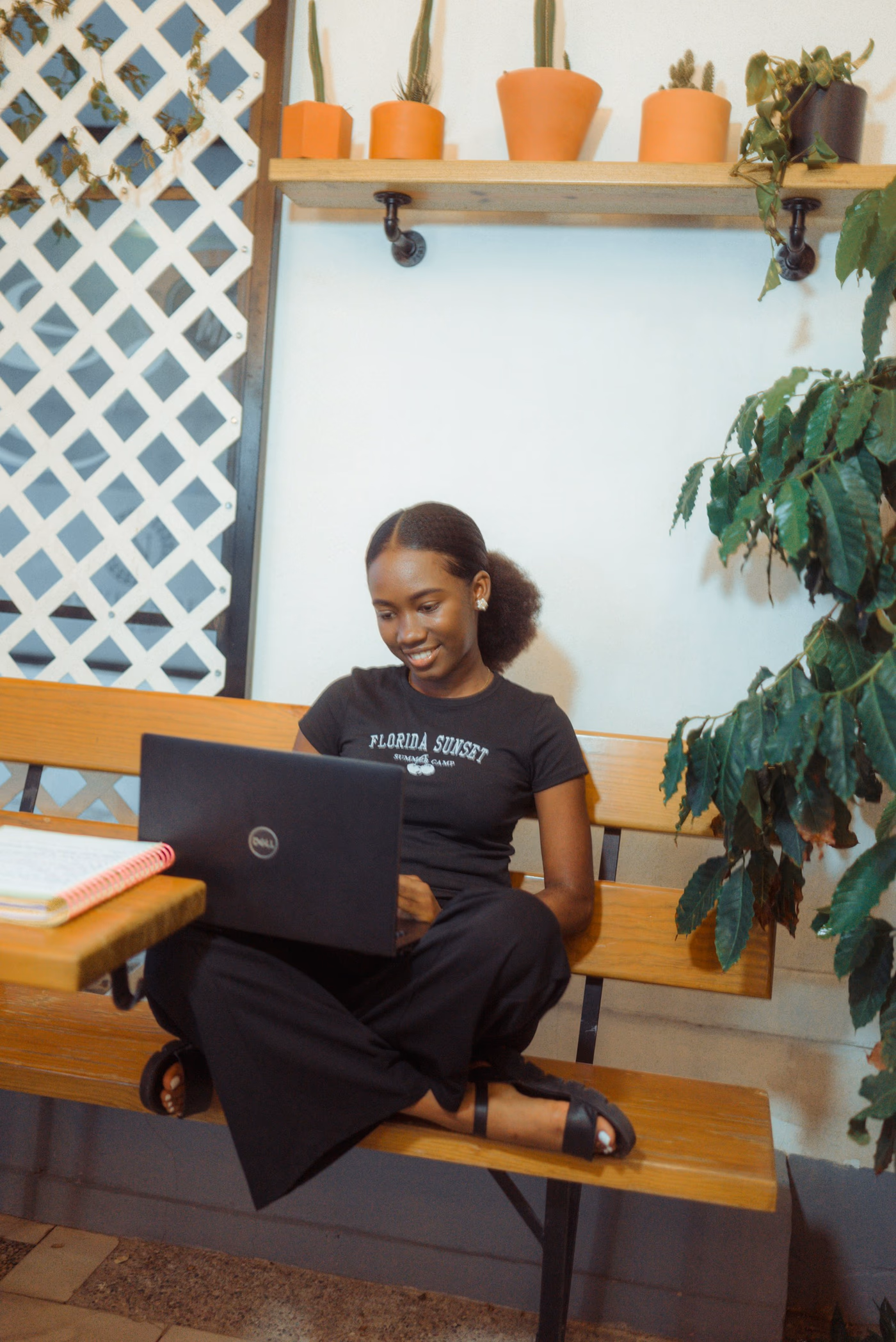 Editorial photograph of a person working on a laptop in a designed workspace — not a Comlabs team portrait